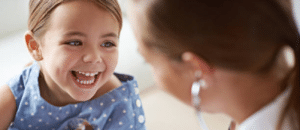 child patient smiling at doctor