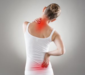 woman touching pain spots on back