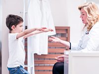 Child getting school physical with doctor